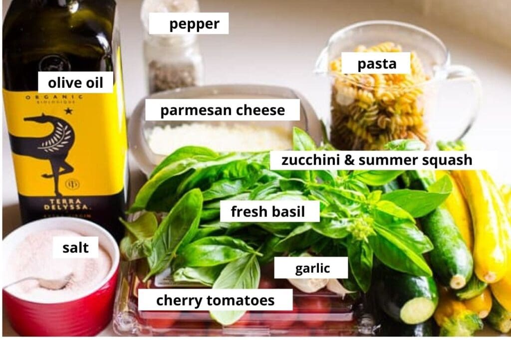 Pasta, cherry tomatoes, fresh basil, zucchini, parmesan cheese, oil, garlic, salt and pepper.