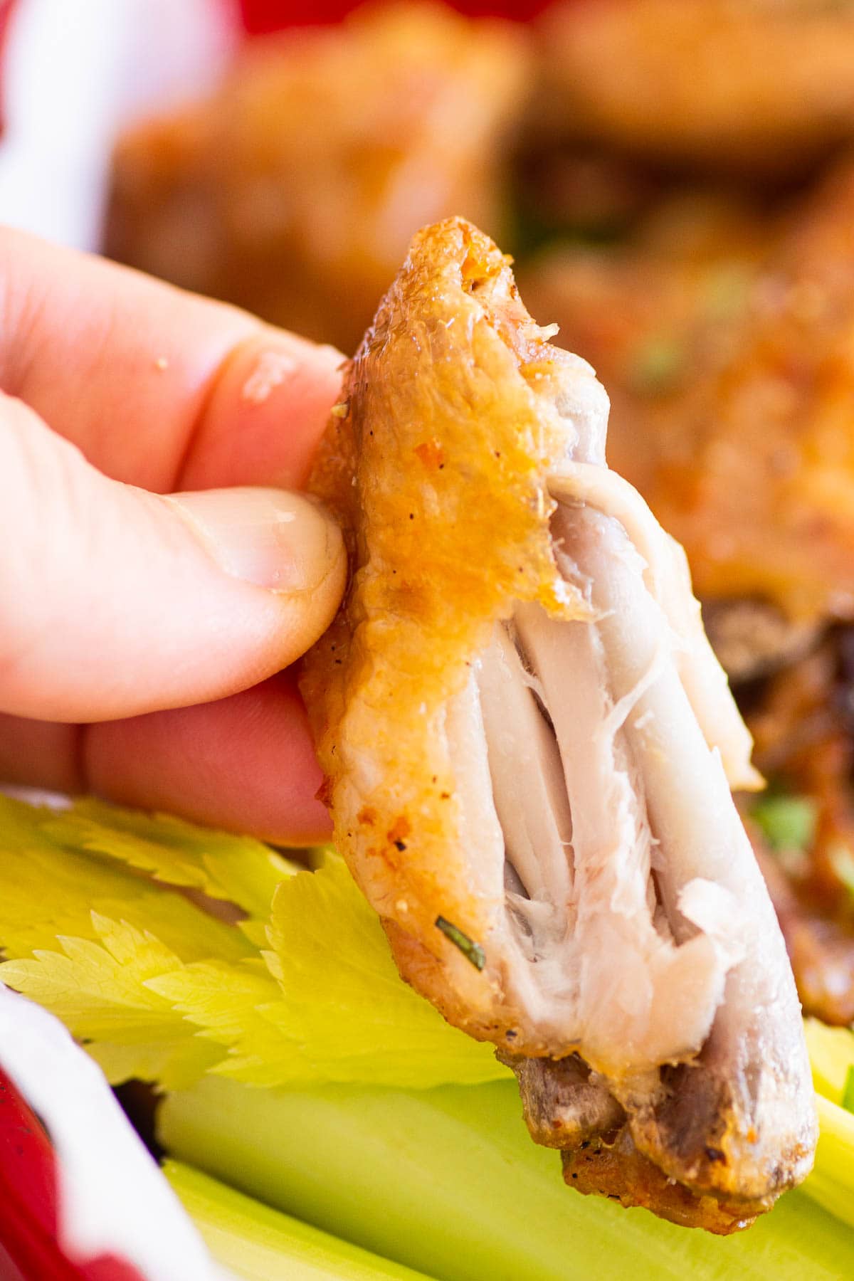 Showing how tender the inside of the chicken wings is.