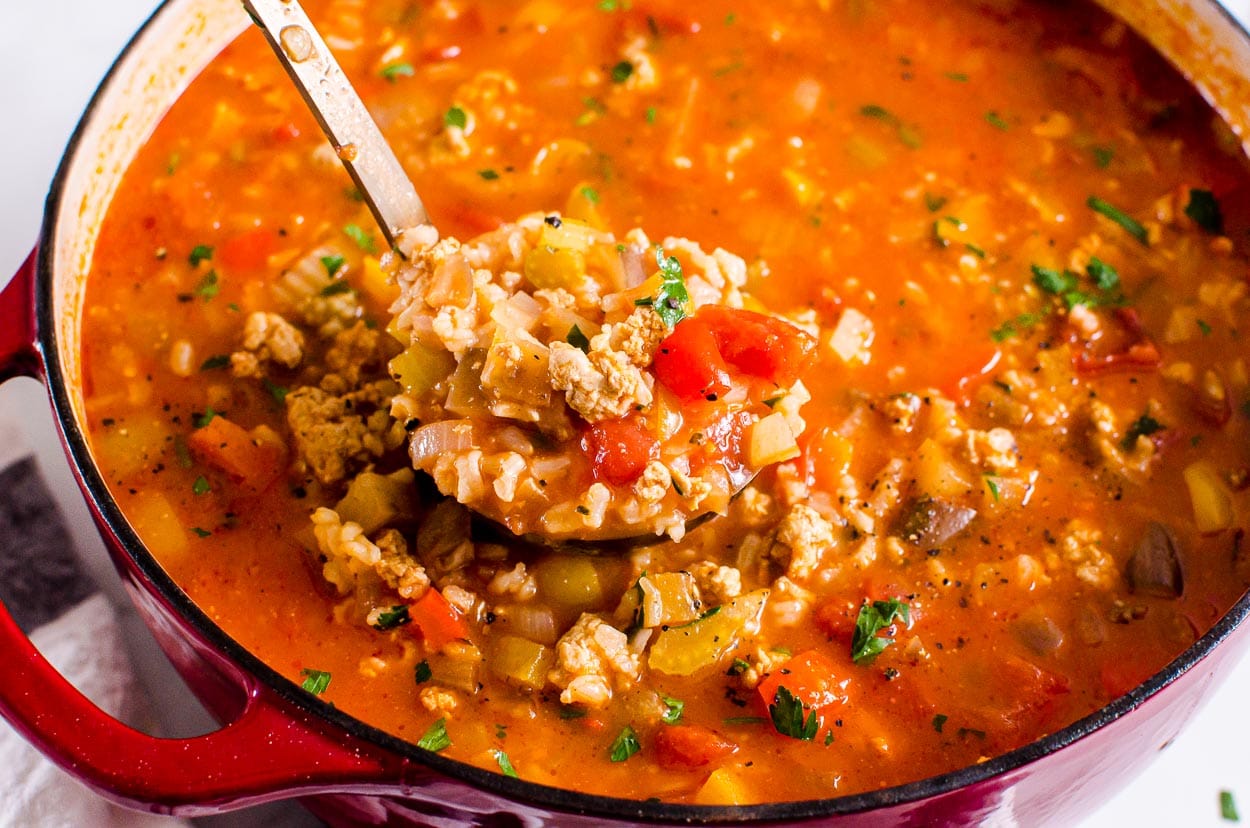 stuffed pepper soup in large pot with ladle