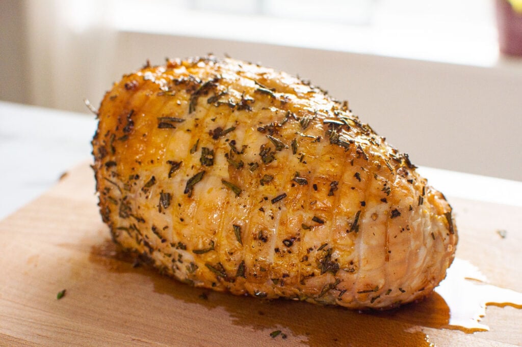 finished boneless skinless turkey breast roast on cutting board