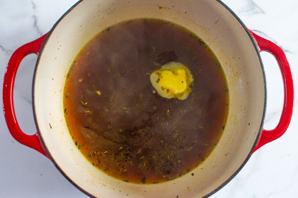 melting butter with wine and broth for turkey gravy