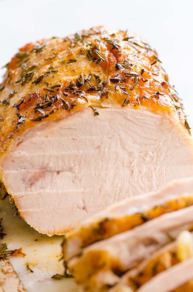sliced boneless turkey breast roast on cutting board