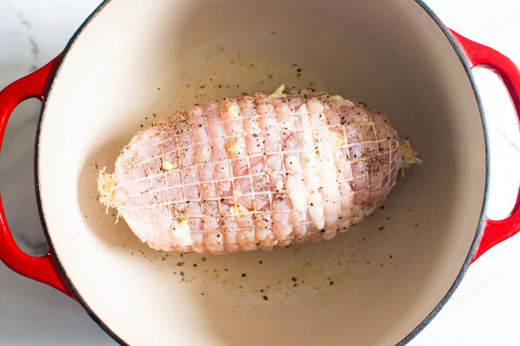 rub boneless skinless turkey with garlic and salt and pepper