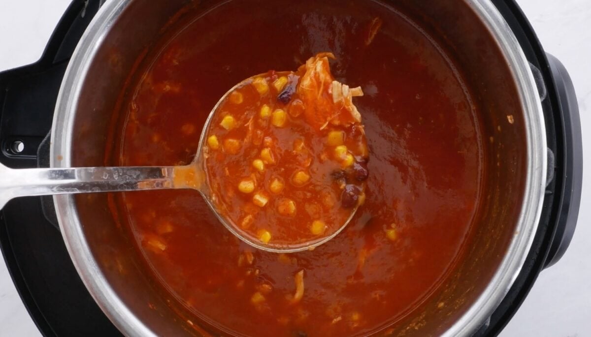 Chicken tortilla soup on a ladle over Instant Pot.