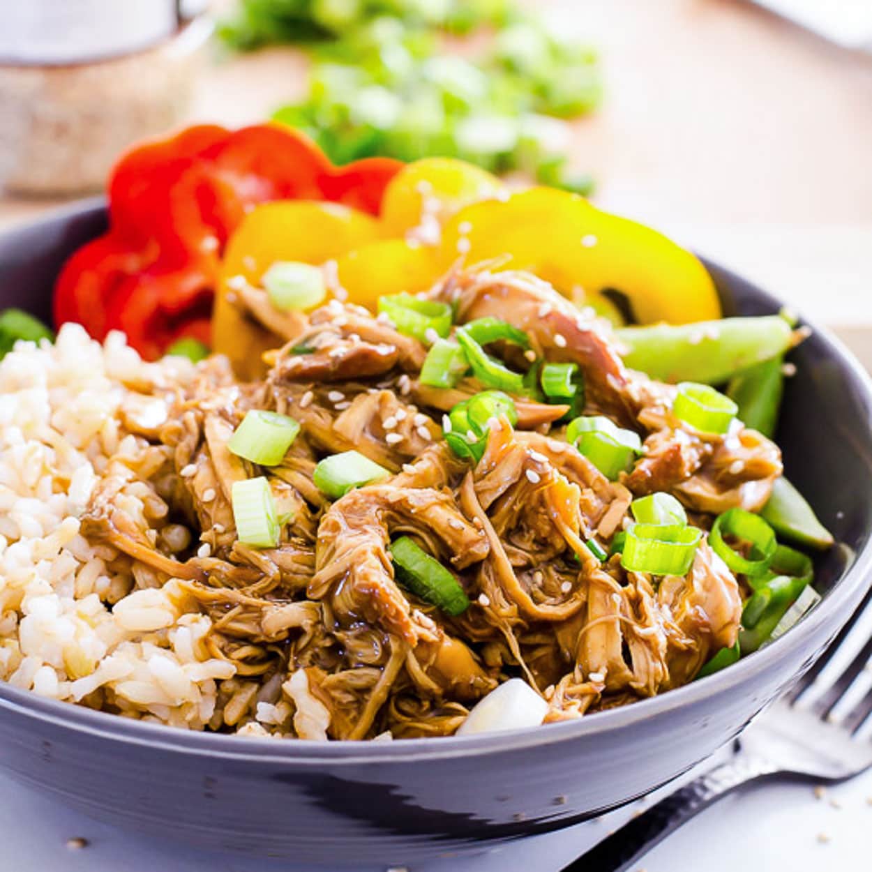 Instant Pot teriyaki chicken bowl with rice and fresh bell peppers for serving