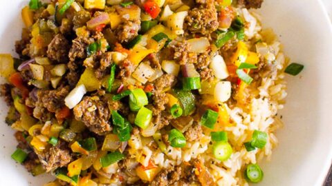 Korean ground beef and rice bowls garnished with green onion.