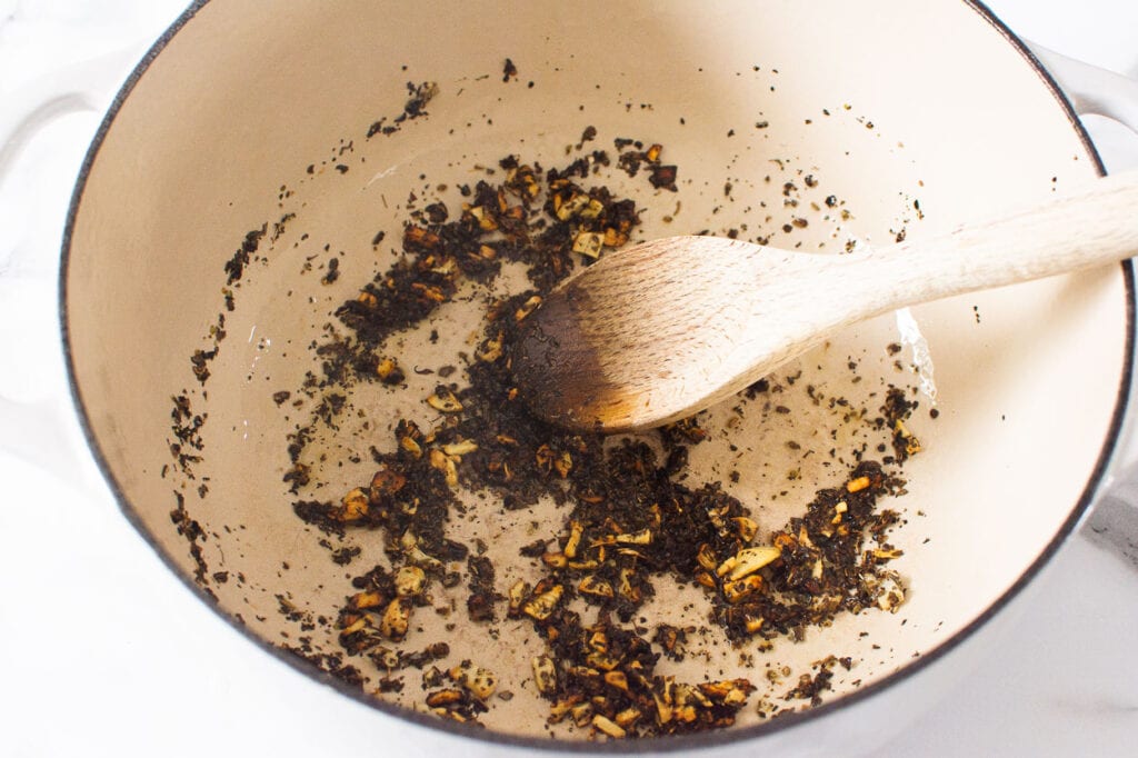 herbs and olive oil being sauteed for easy tomato soup