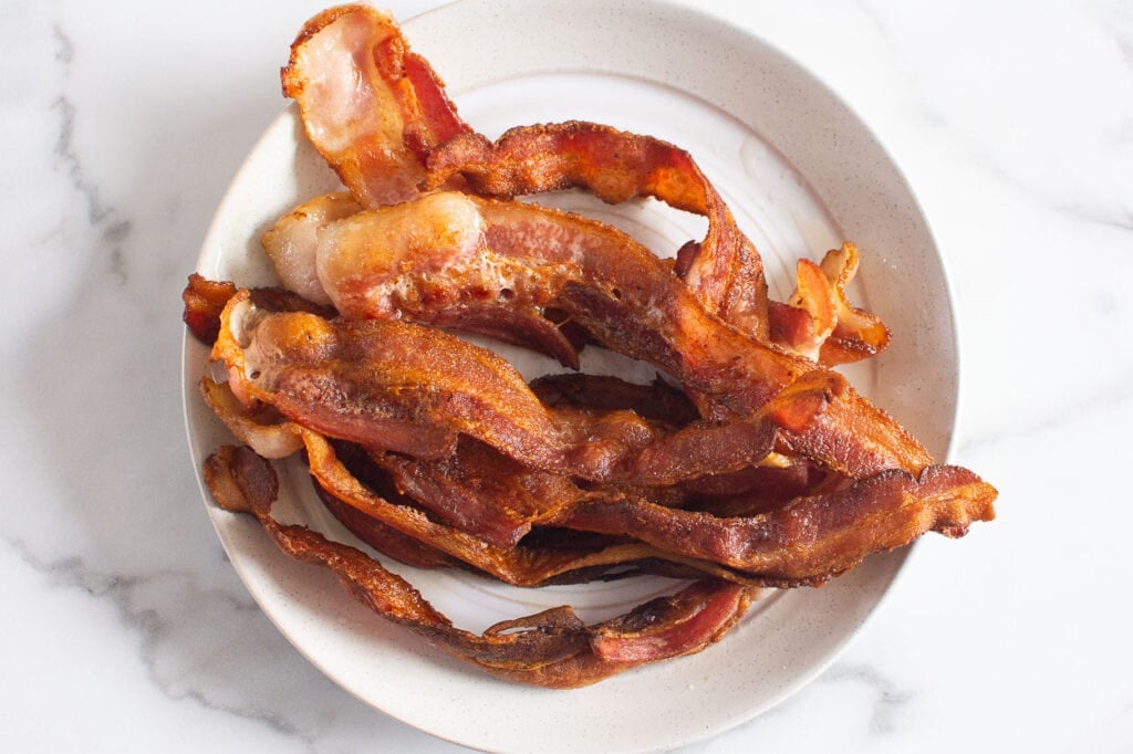 Crispy bacon on white plate.
