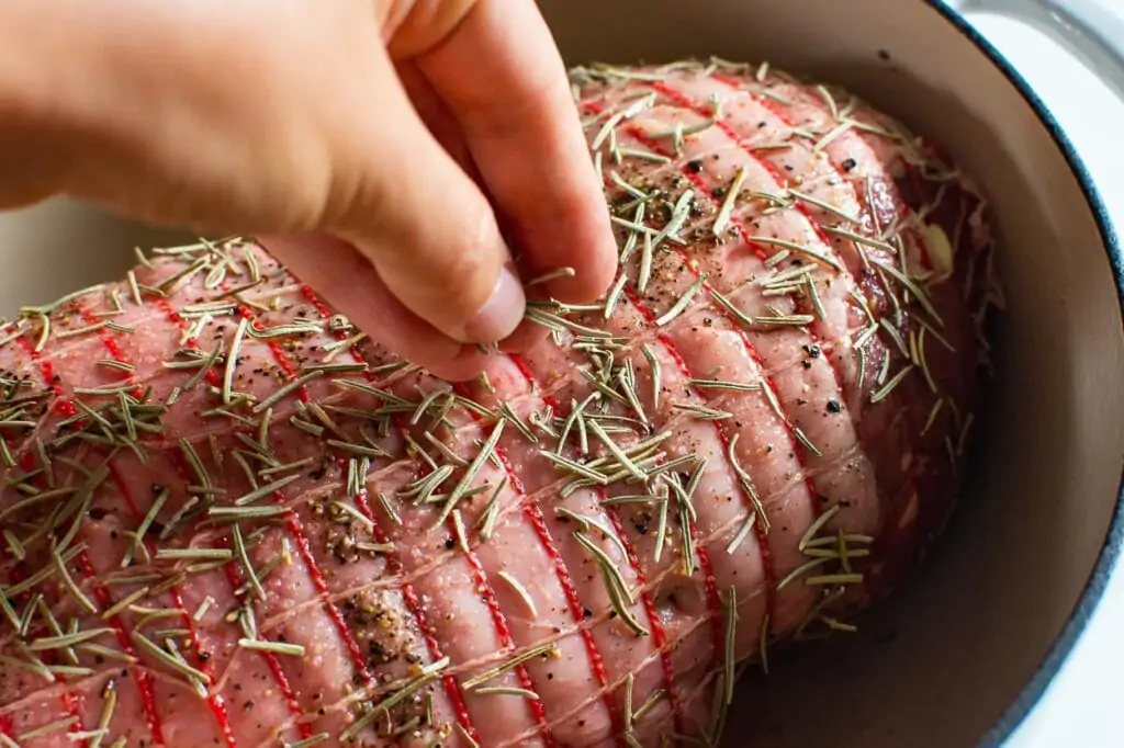 sprinkling roast with herbs and spices