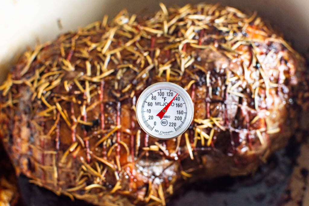 meat thermometer inserted in lamb and says 135 degrees