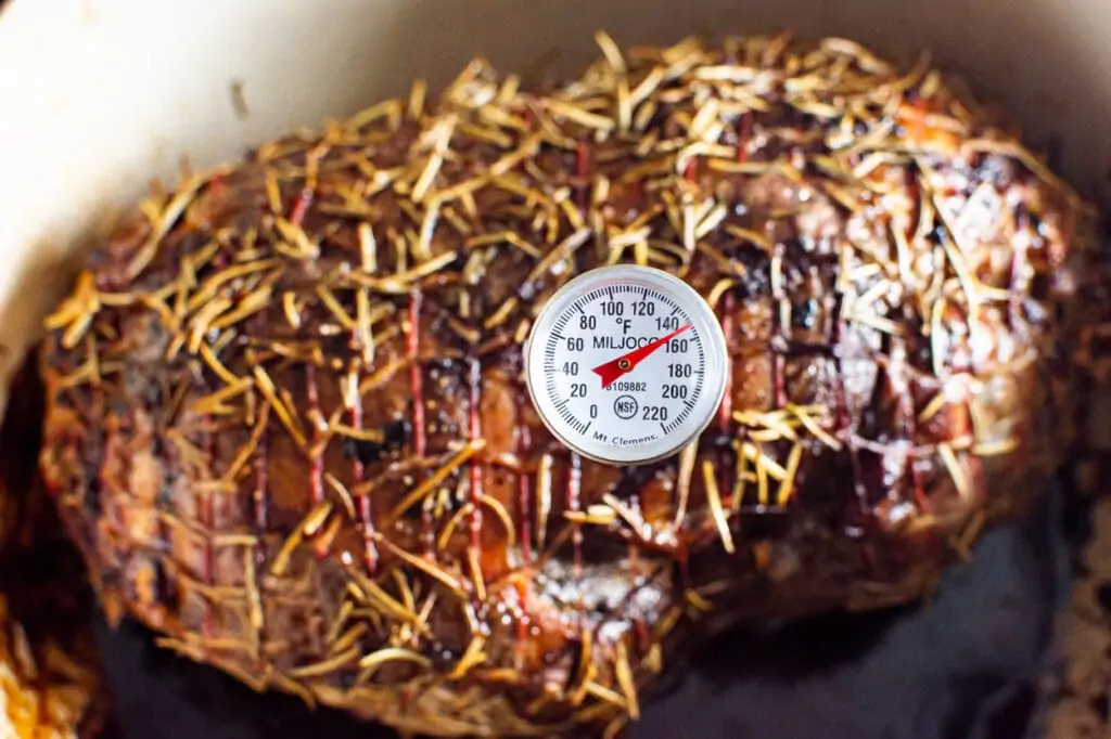 meat thermometer inserted in lamb and says 145 degrees