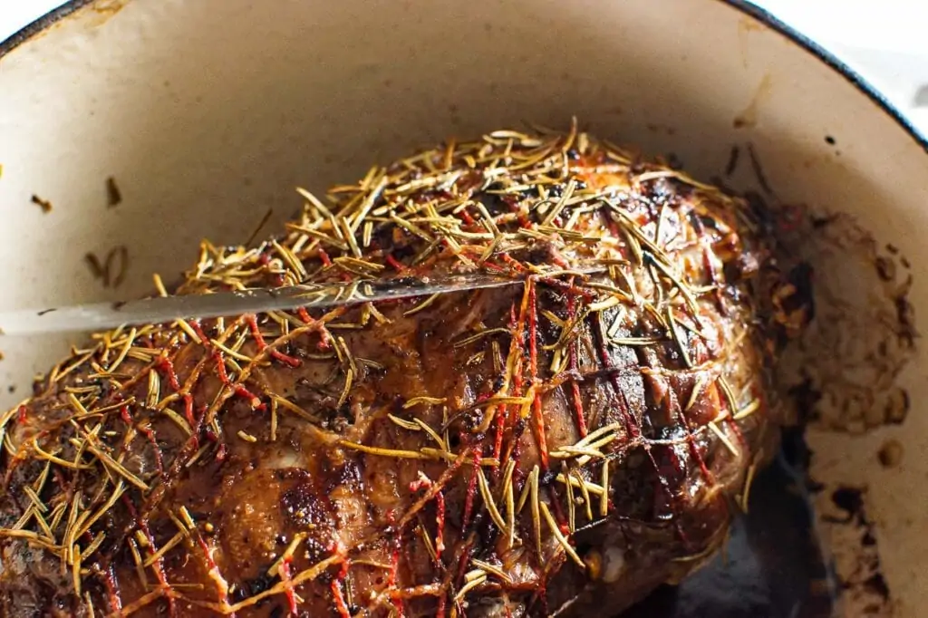 cutting mash with a knife from lamb roast