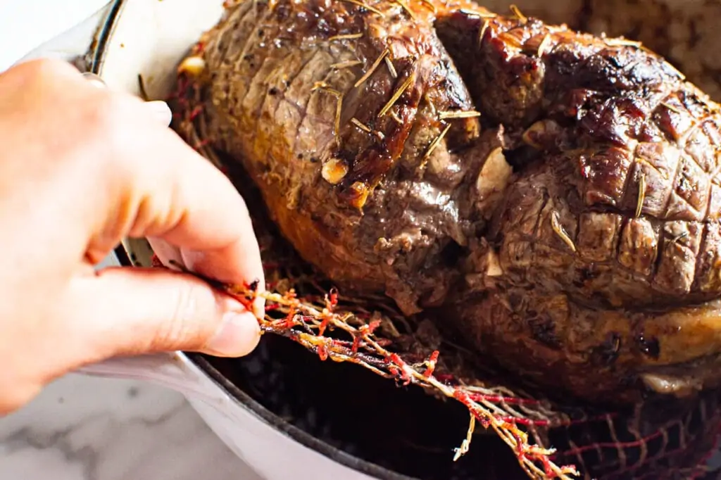 removing mesh from lamb roast