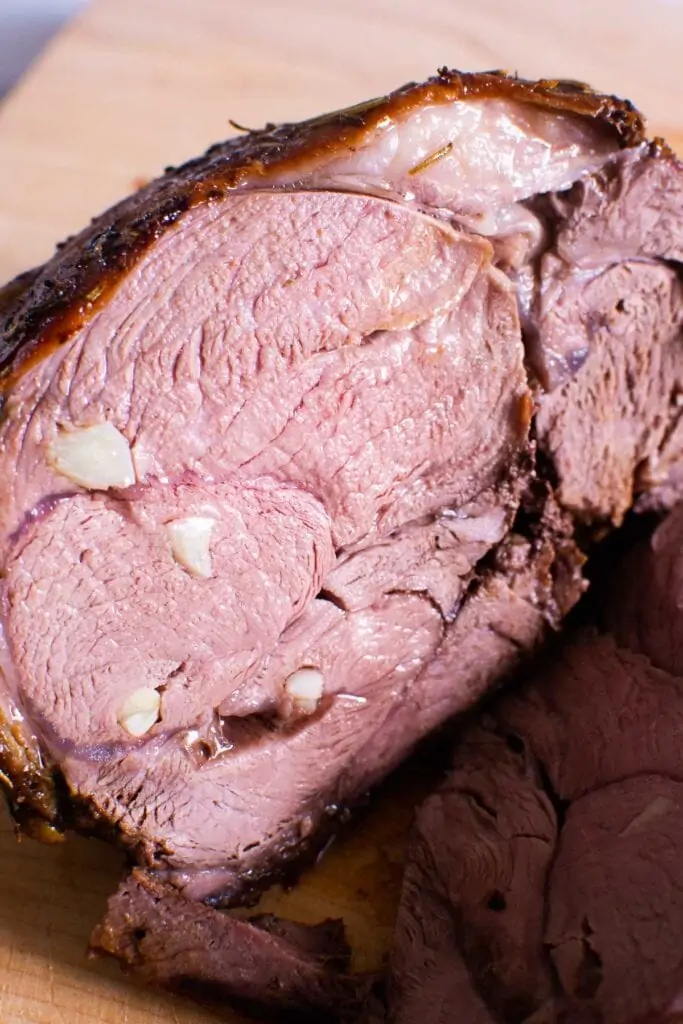 sliced stuffed with garlic leg of lamb