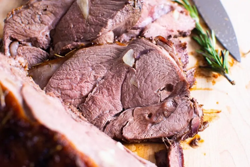 sliced lamb roast on a cutting board