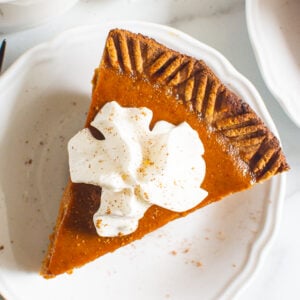 healthy pumpkin pie slice with whipped cream