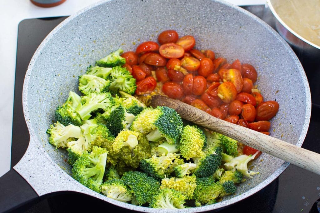 Broccoli and tomatoes in skillet.