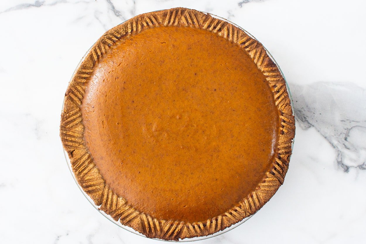 A baked healthy pumpkin pie on counter.
