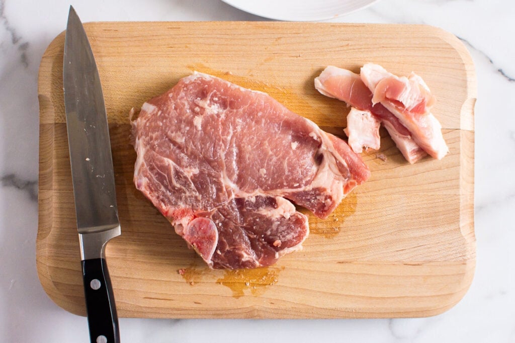 fat trimmed from pork chops on cutting board