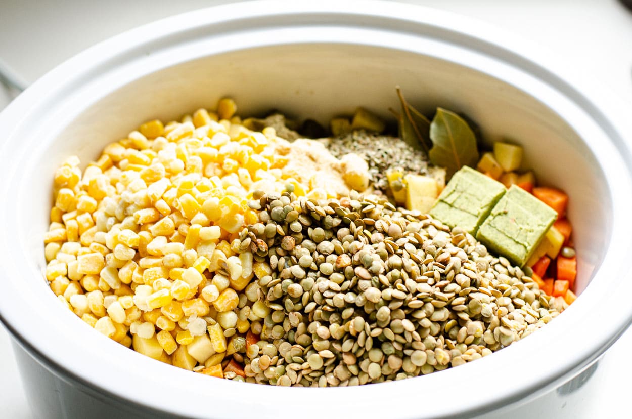 Ingredients for lentil soup inside of crockpot.