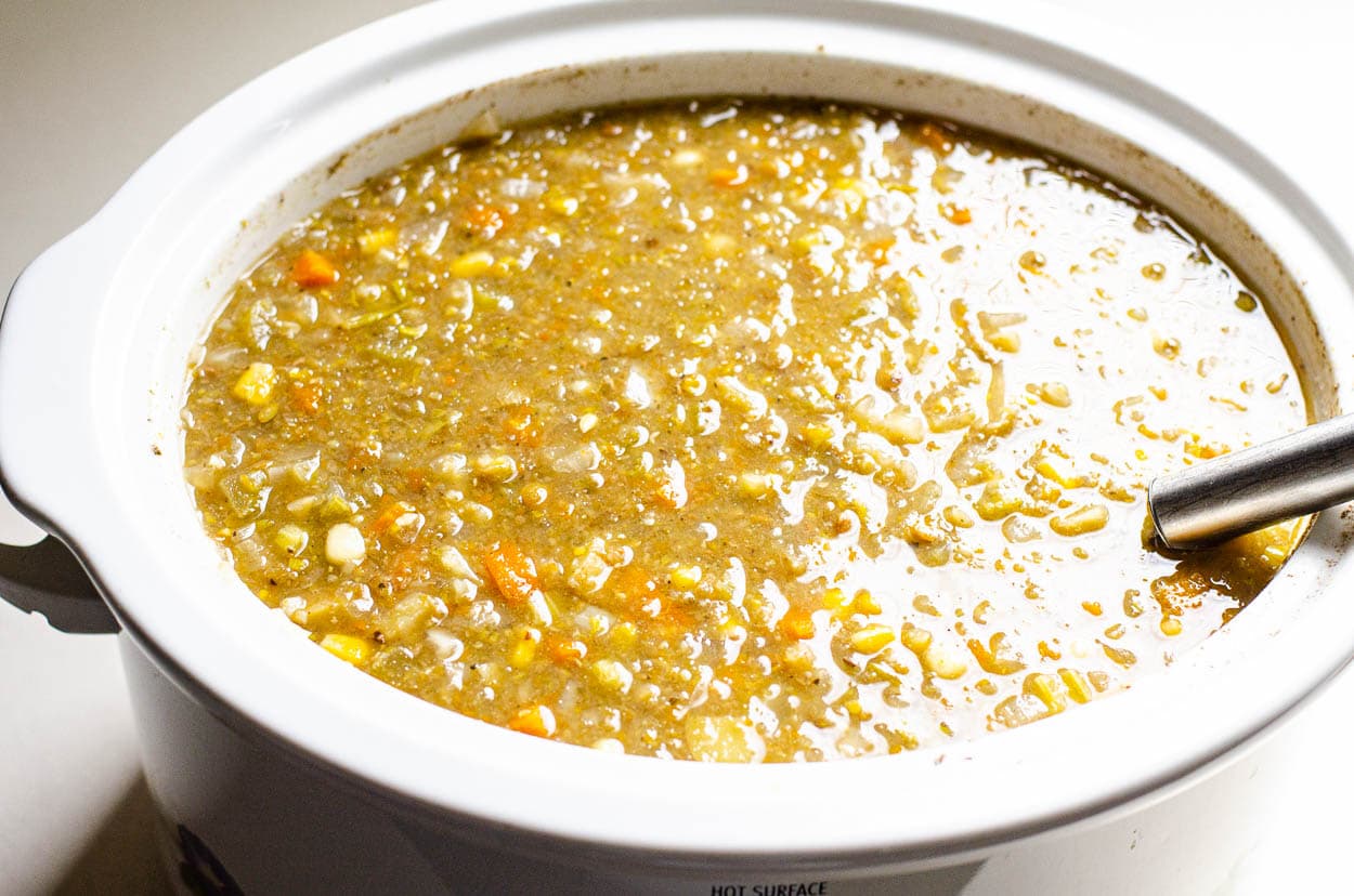 Pureed lentil soup in white slow cooker.