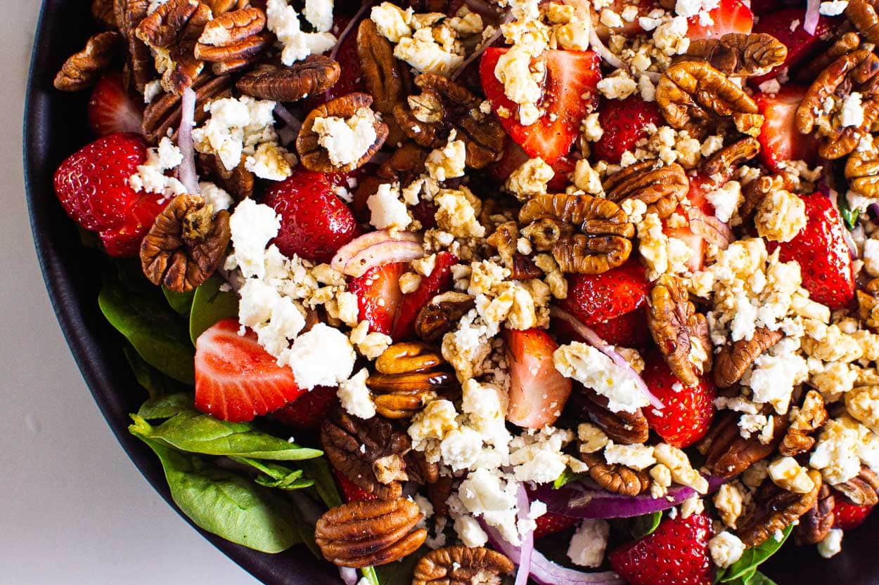 Strawberry and feta spinach salad in a bowl for serving.