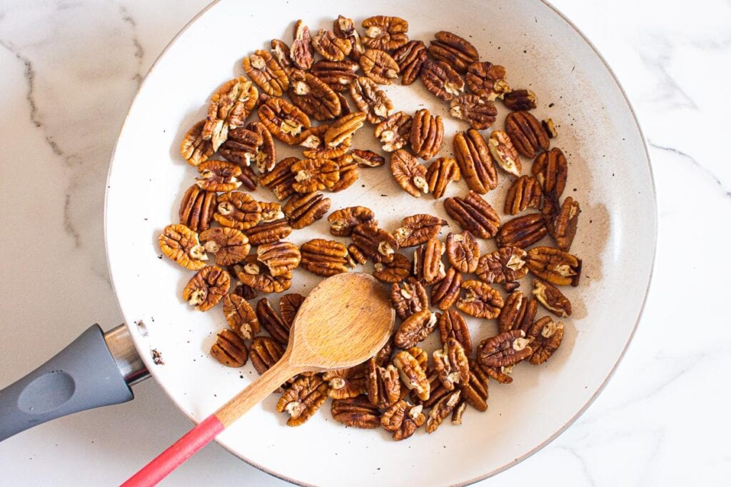 Toasting pecans in a skillet.