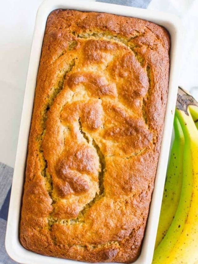 Almond flour banana bread in a pan with fresh bananas.