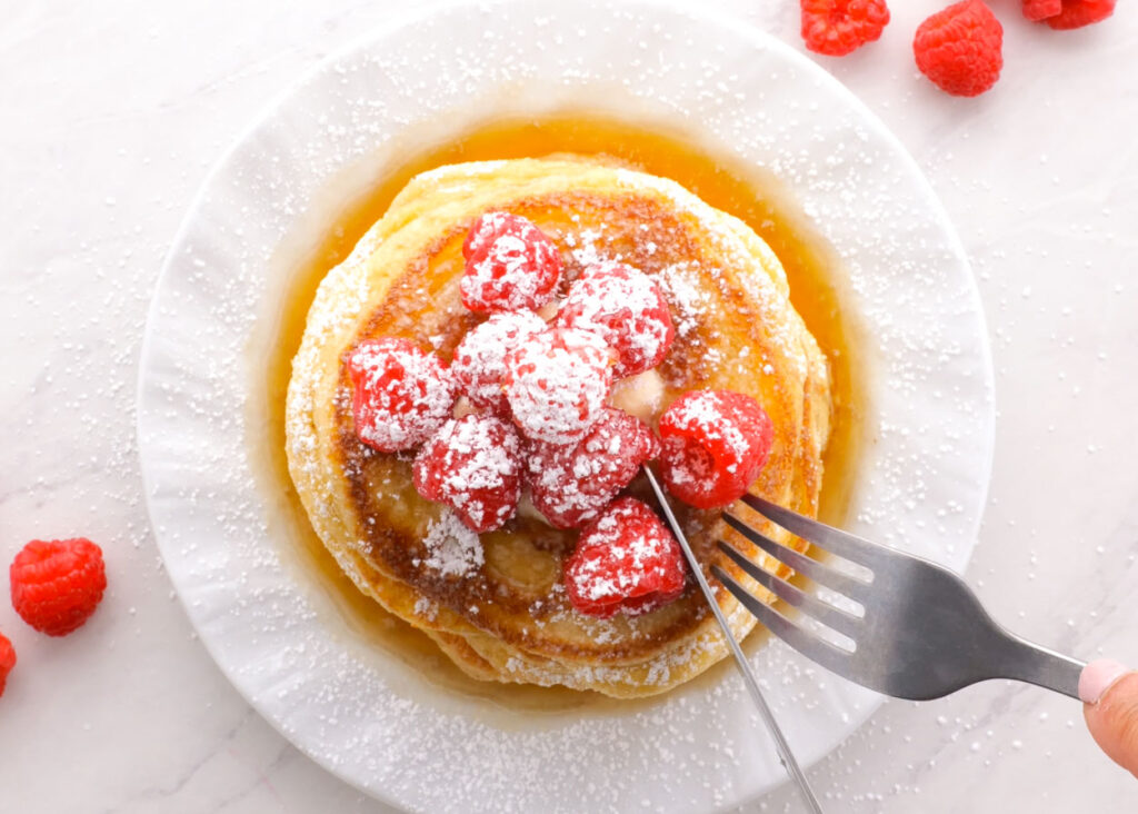 almond flour pancakes with syrup and fresh berries