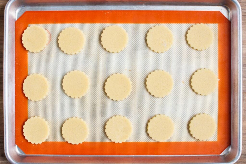 Shortbread cookies on baking sheet lined with silpat.