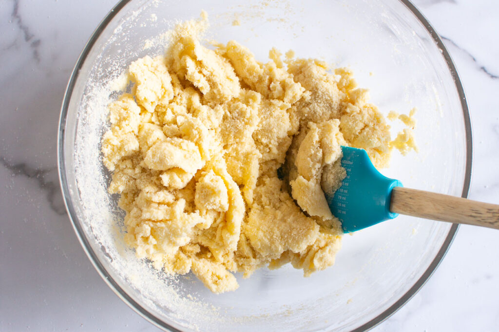 Stirring almond flour into dough.