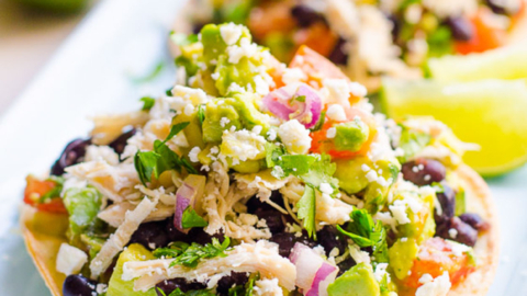 Chicken tostadas served on a blue platter.