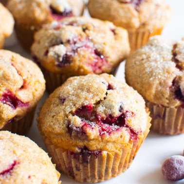 healthy cranberry orange muffins ready to eat with some fresh cranberries