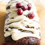 Healthy gingerbread loaf with glaze and cranberries.