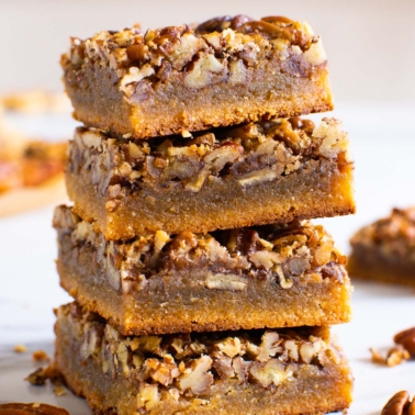 healthy pecan pie bars stacked on top of each other