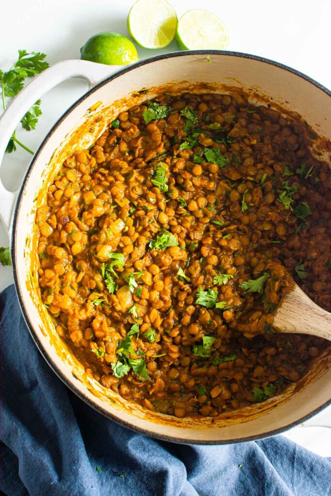 indian lentil dish in a pot with spoon for serving