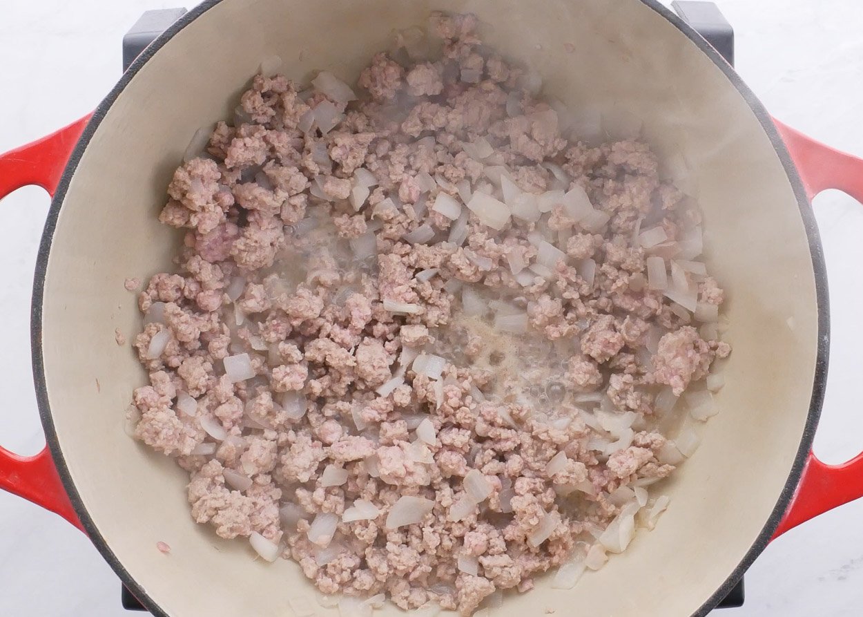 Sauteed ground turkey with onion in pot.