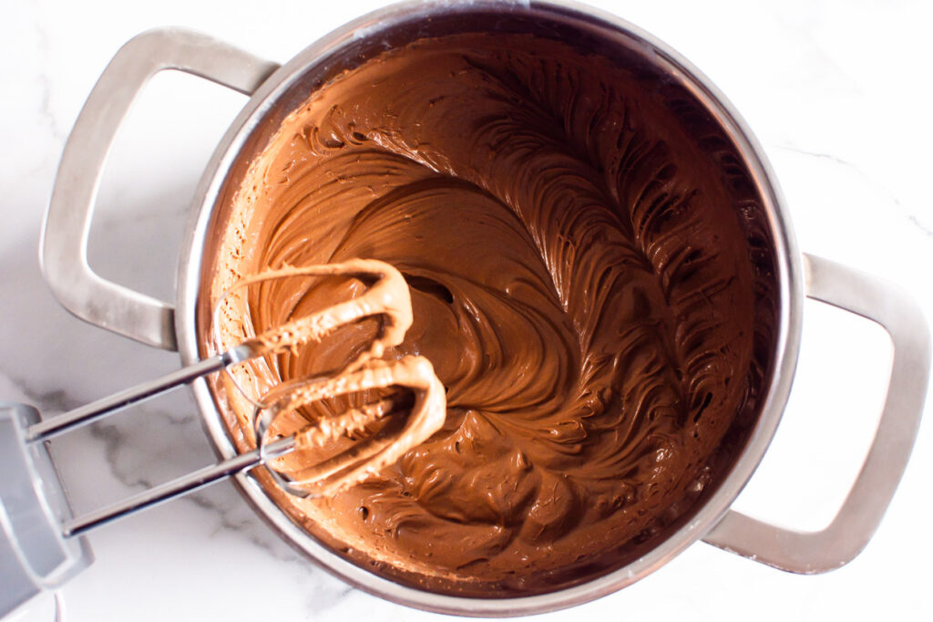 whipped chocolate ganache in a pot, and electric mixer
