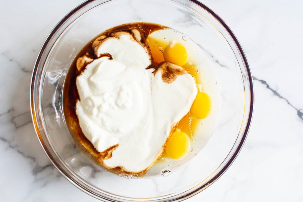eggs, yogurt, maple syrup in glass bowl