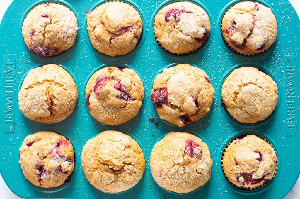 full pan of finished healthy cranberry muffins with orange
