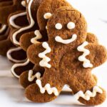 gingerbread men stacked and ready to eat with red oven mitt