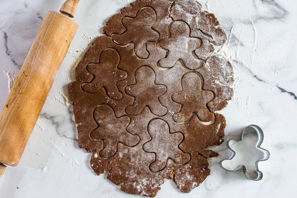 gingerbread cookie dough cut out into shapes