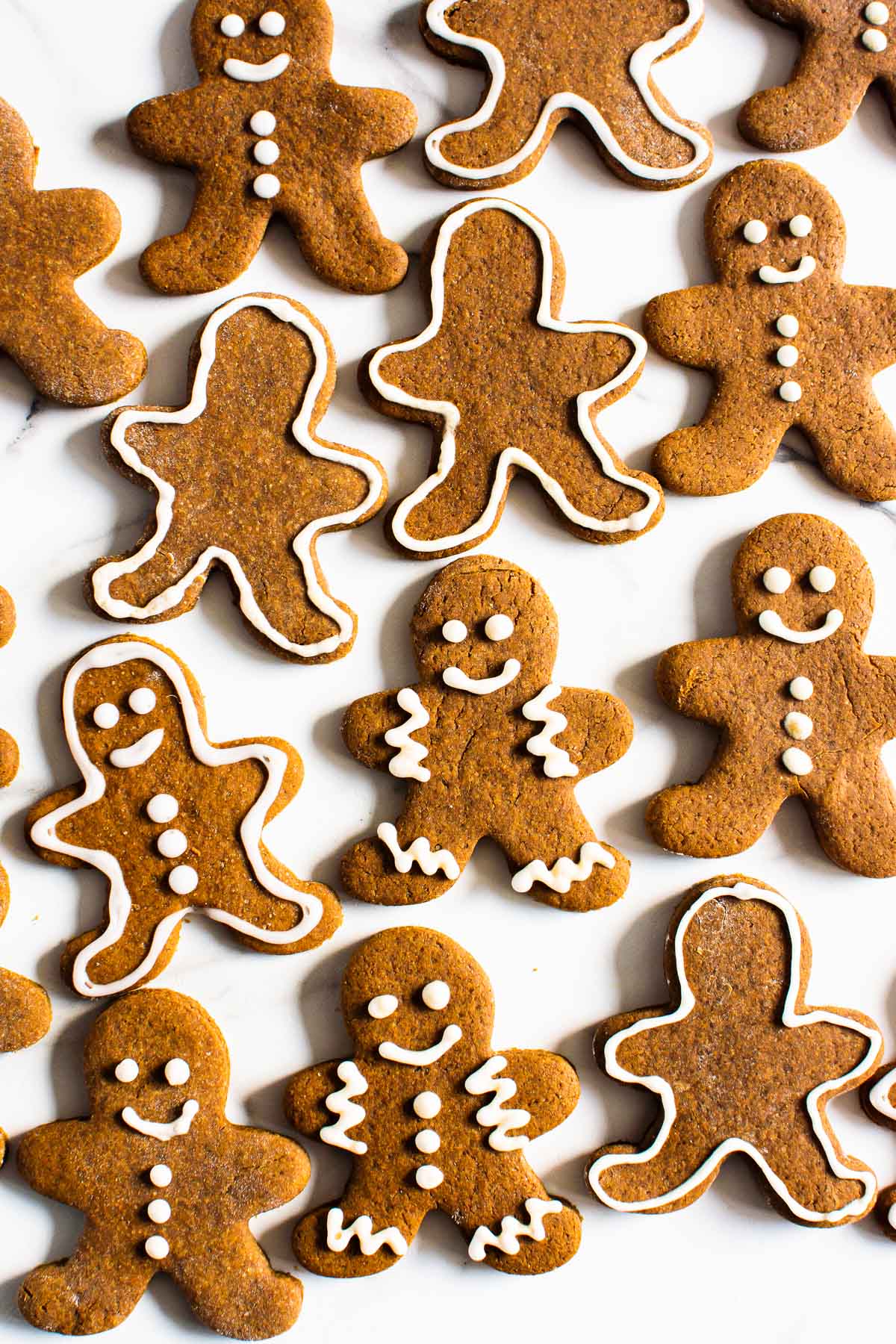 Healthy gingerbread cookies with icing o na counter.