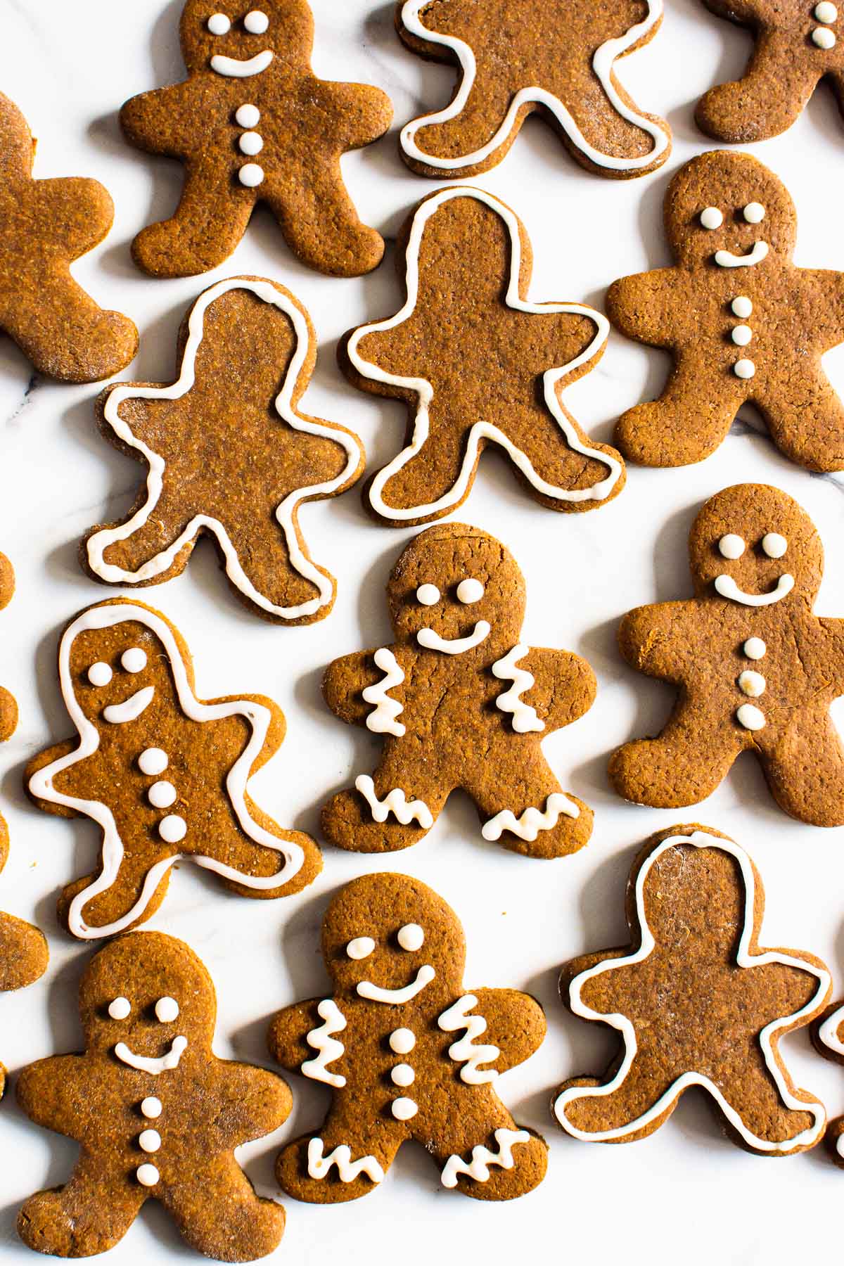 Healthy gingerbread cookies with icing on a counter.