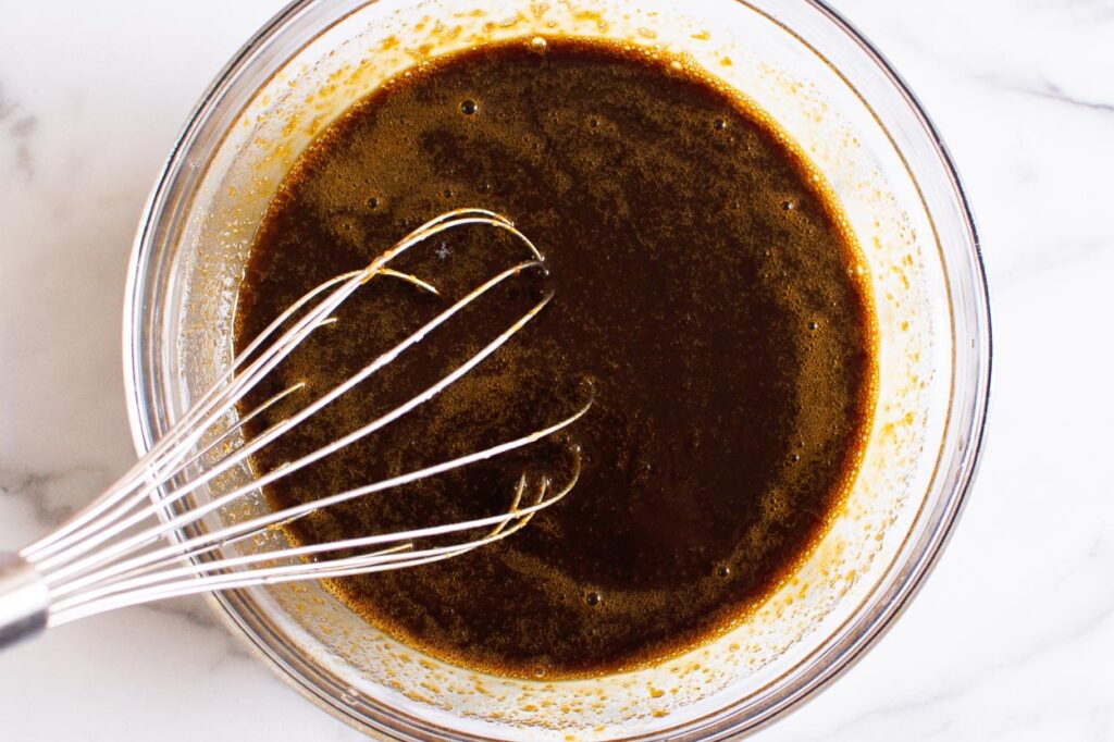 mixing molasses into liquid ingredients with whisk