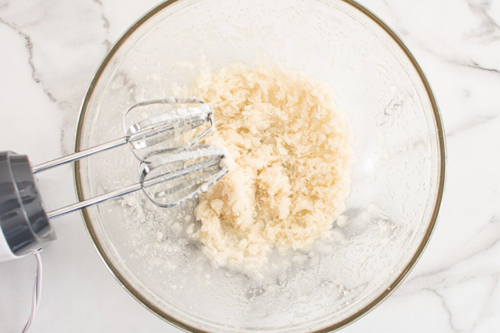 Cream coconut oil and sugar in bowl. 