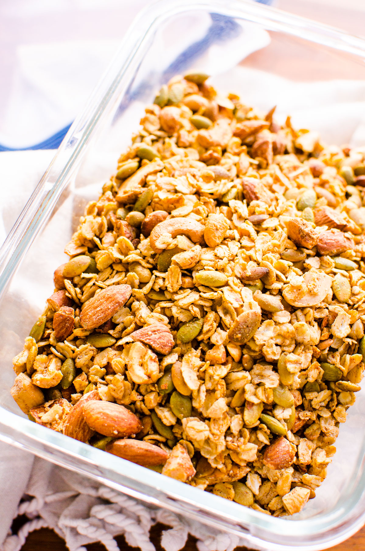 Healthy granola with nuts and seeds in glass container.