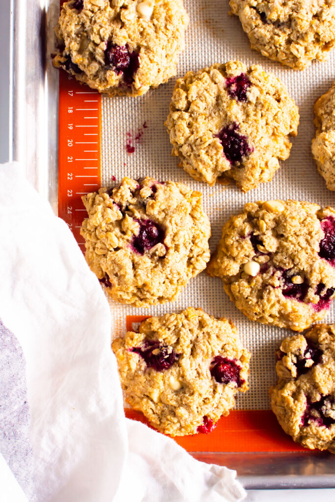 healthy cranberry white chocolate chip oatmeal cookies on silpat mat in baking pan