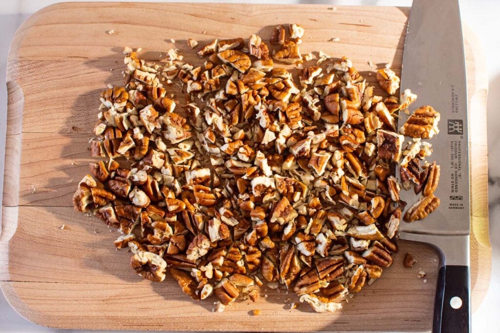 Chopped pecans on cutting board.