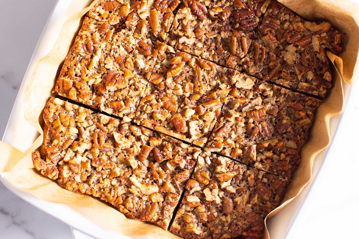 Pecan pie bars cut into squares for serving.